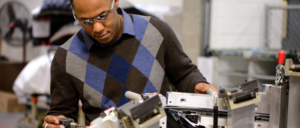 Man performing quality tests in auto factory